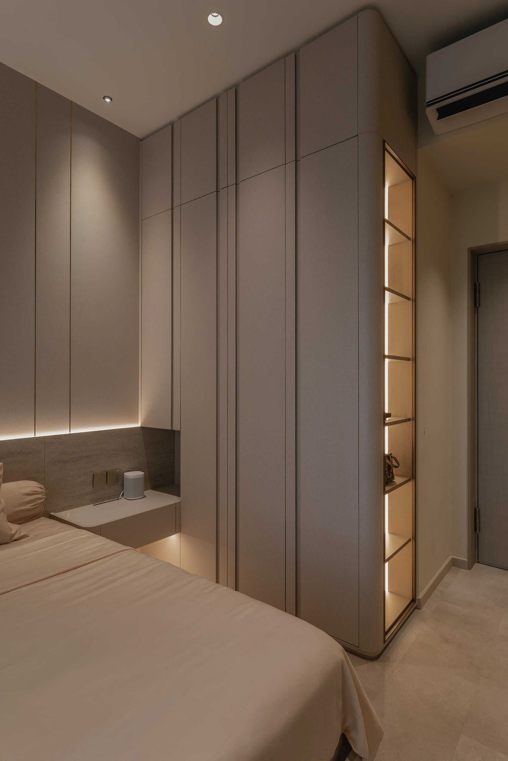 Bedroom with full-height wardrobes and integrated bedside ledge by Edgeline Planners