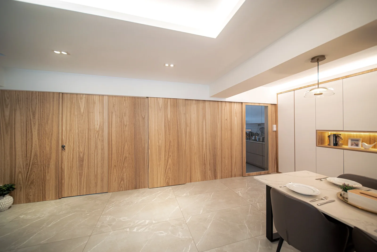 J Concept Designers &mdash; continuous natural wood veneer feature wall with four concealed doors