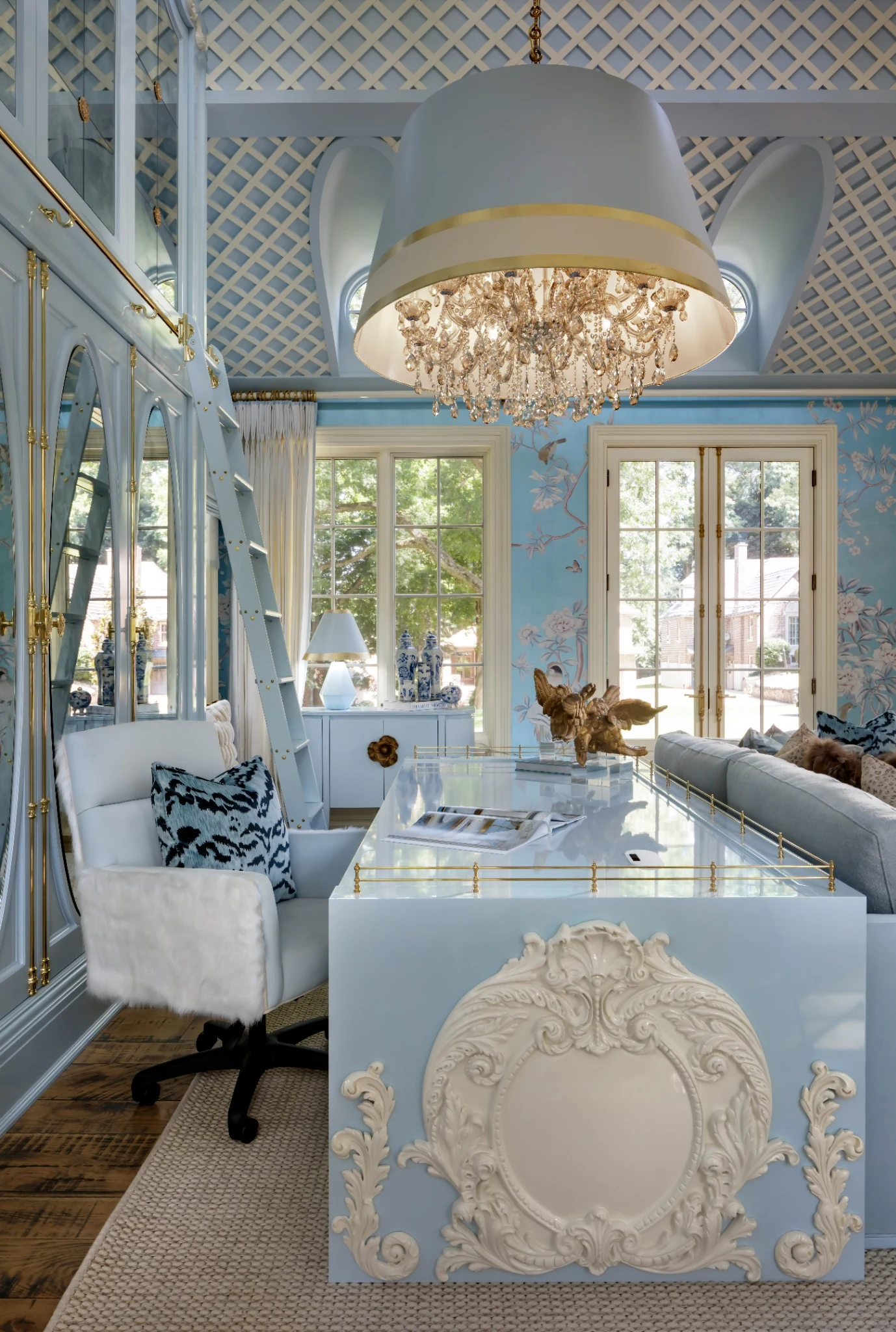 Lori Morris Design &mdash; custom glossy powder blue desk with hand-carved appliques, brass gallery rails and library ladder beyond