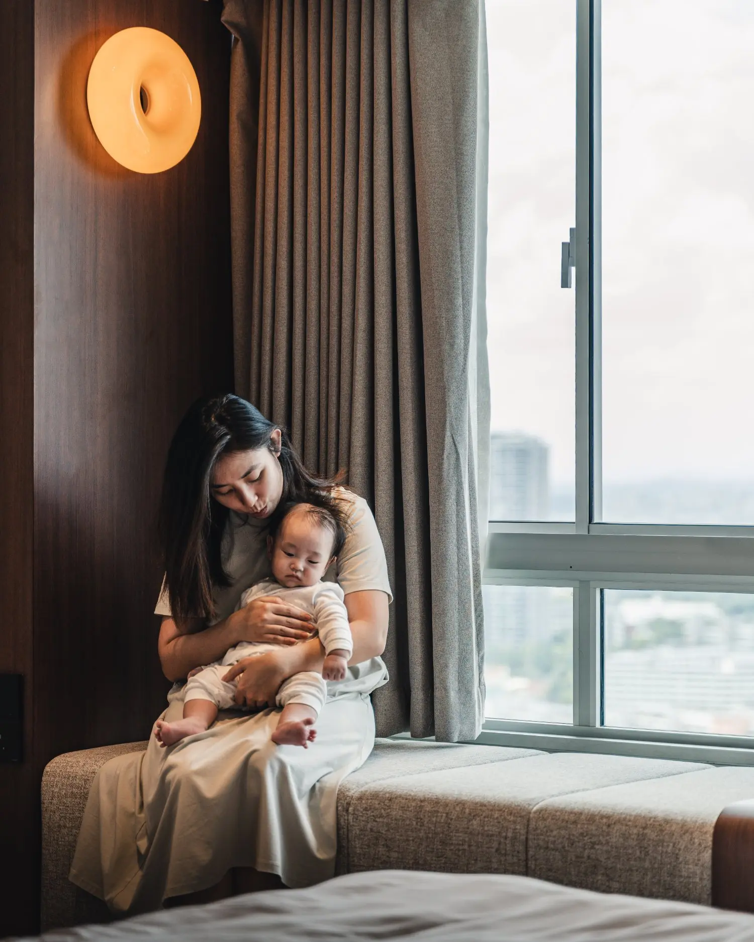 Family seated at the master bedroom bay-window lounging nook