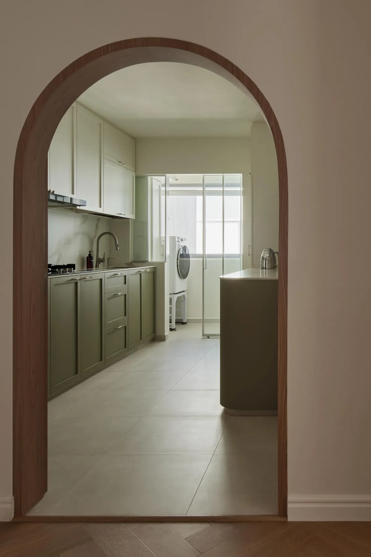 Arched sliding glass kitchen door inspired by a farmhouse barn door