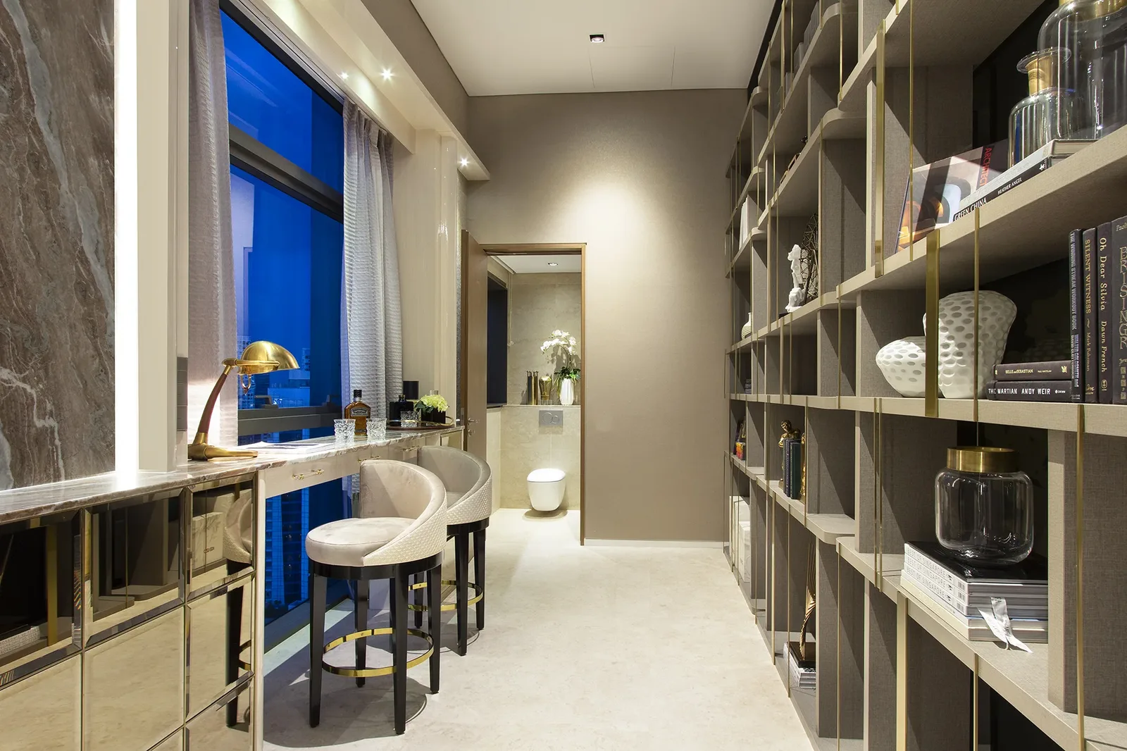 SuMisura &mdash; floor-to-ceiling library bar with brass dividers and city view